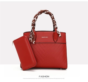 Detail of red tote bag and matching long wallet with silk scarf wrapped handle decoration