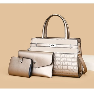 Three-piece champagne gold handbag set with croc-embossed texture and silver lock details