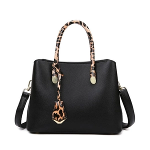 Elegant black lychee leather tote with leopard print handles and gold-tone hardware