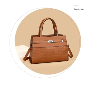 Detail of brown crocodile pattern handbag with metal twist lock and elegant leather splicing