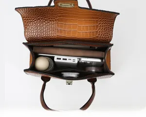 Interior view of brown crocodile tote bag showing spacious compartments and storage
