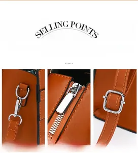 Detailed view of silver metal hooks and adjustable strap hardware on a vintage brown bag