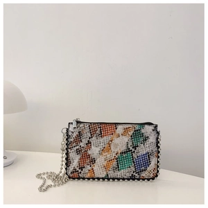 Macro view of colorful snake print bag with silver bead studs and metal ball chain
