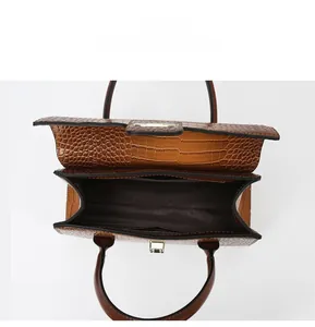 Internal view of brown tote bag with dual compartments and embossed crocodile texture