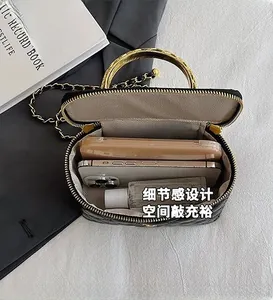 Interior view of black quilted mini bag showing spacious storage for phone and cosmetics