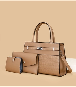 Three-piece leather bag set featuring a crocodile embossed tote and matching pouches