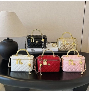 Detailed group view of quilted crossbody mini bags in five elegant colors on a desk