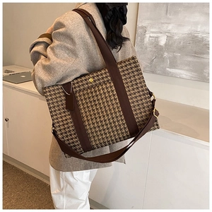 Detail of retro houndstooth tote bag with large capacity and brown adjustable straps