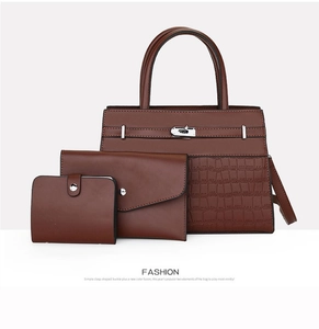 Close-up of brown three-piece bag set with crocodile texture and silver metal lock
