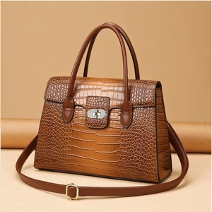 Classic brown crocodile embossed tote bag with silver twist lock and adjustable strap