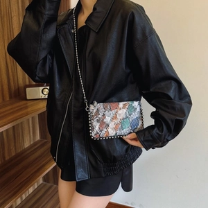 Multicolor snakeskin crossbody bag with metal chain strap and spherical rivet details