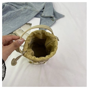 Detailed interior of champagne sequin bucket bag with drawstring closure and fabric lining