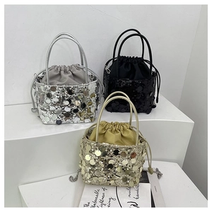 Close-up of sparkling sequin bucket bags with drawstring liners and metal chain straps
