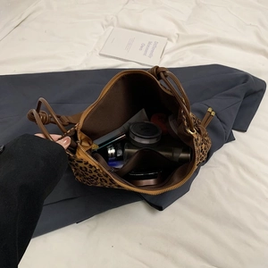Détail du sac cabas léopard en nylon montrant la poche intérieure zippée et la contenance