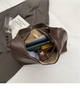 Top view of dark brown tote bag interior showing spacious capacity for phone and umbrella