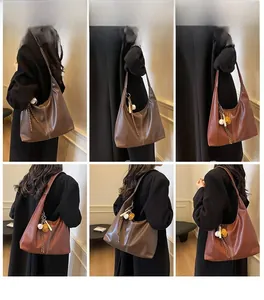 Detailed model views of a brown leather hobo bag with contrast stitching and charms