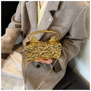 Elegant gold metal evening clutch bag with wrinkled texture and lion head accents