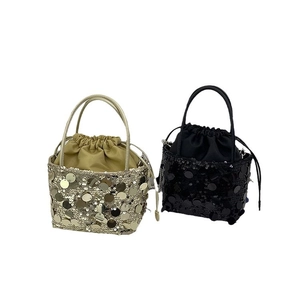 Glittery sequin bucket bags in gold and black with drawstring closure and twin handles