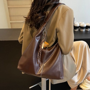 Dark brown large capacity tote bag with white contrast stitching and strawberry charm