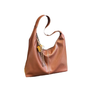 Minimalist brown hobo shoulder bag with contrast stitching and yellow pendant charm