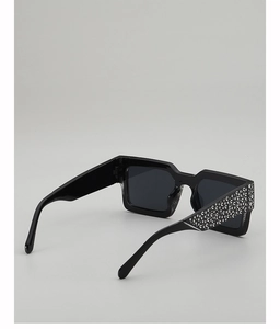 Detail of square sunglasses with sparkling rhinestone embellishments on thick black temples