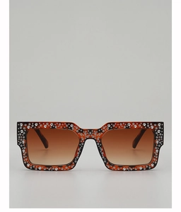 Macro shot of rectangular tortoiseshell sunglasses with crystal embellishments