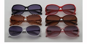 Flat lay of colorful oversized square sunglasses in black, red, leopard, and white frames