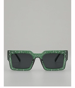 Detail of green rectangle sunglasses frame featuring sparkling rhinestones and black lenses