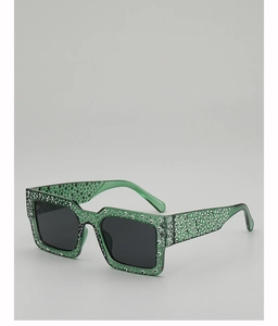 Detail of green rectangle sunglasses with silver rhinestones and dark lenses