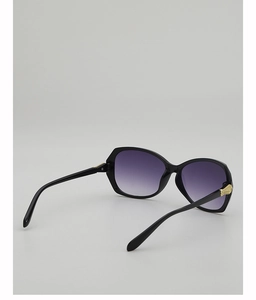 Close-up of golden geometric metal hinges on stylish oversized purple gradient sunglasses