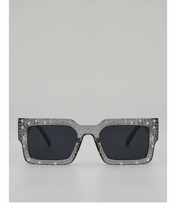 Detailed macro view of square sunglasses featuring densely embedded rhinestones and dark lenses