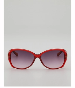 Detailed view of red translucent butterfly frame sunglasses with gold metal hinges