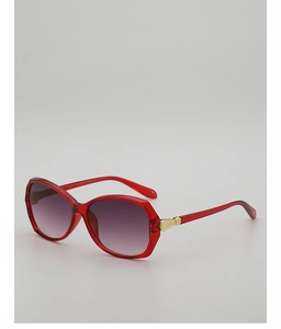Detail of red oversized sunglasses with purple gradient lenses and gold temple accents