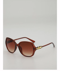 Detailaufnahme der rotbraunen Acetat-Sonnenbrille mit Verlaufsgläsern und Goldakzenten