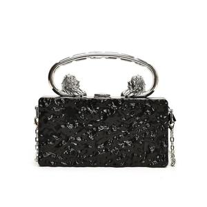 Acrylic box clutch with stone texture, lion head metal handles, and silver chain strap
