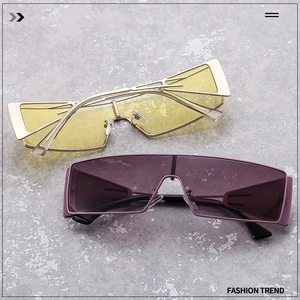 Close-up of futuristic rimless metal sunglasses with yellow and purple lenses