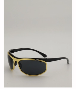 Detail view of large y2k style sunglasses with black frame and gold metal trim