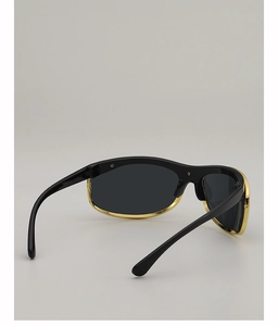 Detail of Y2K sunglasses with black thick frame and golden metal inner lining accents