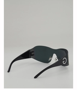 Side view of black Y2K wraparound sunglasses featuring silver metal G logo on the temple