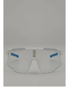 Detail of white cycling goggles featuring large clear lenses and blue non-slip temple tips