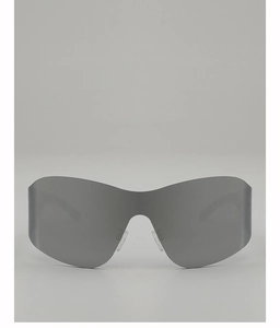 Close-up of grey mirrored lenses on futuristic Y2K wrap-around cycling sunglasses