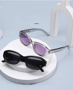 Detailed close-up of geometric cat-eye sunglasses with silver wave-patterned temples