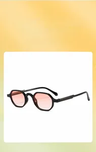 Detail of kids black polygonal sunglasses with pink gradient lenses and chic retro style