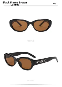 Detail of cat-eye sunglasses with thick black frame and silver moon accents