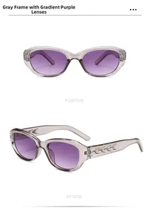 Detail view of oval cat-eye sunglasses with grey frames and gradient purple lenses