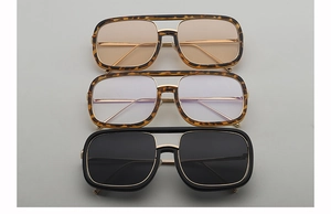 Close-up of retro double-bridge square sunglasses in tortoiseshell and black frames