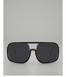 Close-up of black square sunglasses with gold metal double bridge and wide frames