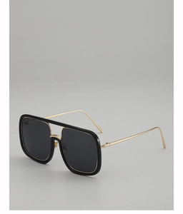 Detail of square black sunglasses with gold metal trim and slim temples for men