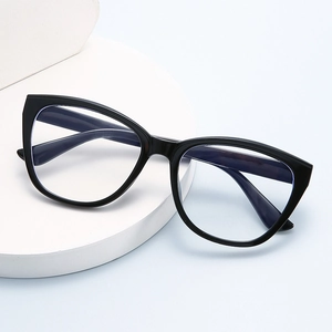 Modern black cat-eye glasses frame with blue light blocking lenses on a white tray