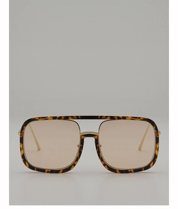 Detailed macro view of tortoiseshell square frame sunglasses with golden double bridge
